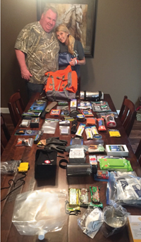Greg and Evette Sissel displaying the contents of their bug-out bag.