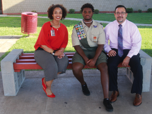 Stafford High School’s Misti Morgan, Frederick McCloud and Silas Garcia on the benches McCloud created as part of his Eagle Scout project.