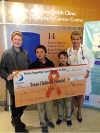 Peyton Richardson, Ben Mize, Caleb Cook and Dr. ZoAnn Dreyer with Ben’s donation to Texas Children’s Cancer Center.